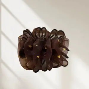 Vue détaillée de la pince à cheveux en organza marron avec des accents dorés.