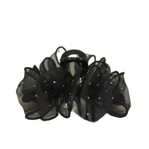 Black organza hair claw clip with rhinestone star dots, elegant hair accessory for women.