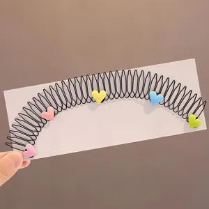 Close-up detail of the cute colorful heart hair comb for kids, flexible teeth design.
