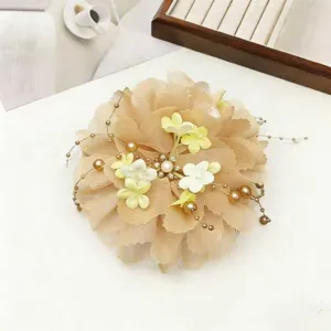 Detail view of the elegant peony flower hair claw clip with delicate pearl tassel chains.