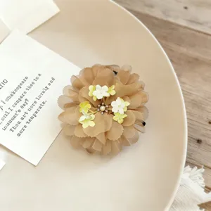 Chiffon flower hair claw clip with delicate pearl details and mesh petals for elegant styling.