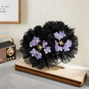 Elegant black mesh flower hair claw clip with purple floral and pearl accents for stylish hair bun.
