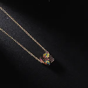 Detailed close-up shot of an elegant rose gold necklace featuring a sparkling colorful crystal LOVE pendant.