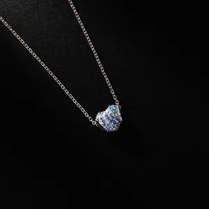 Detail shot of a women's blue rhinestone heart pendant necklace with a fine silver chain.