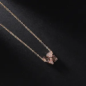 Rose gold tone LOVE pendant necklace with sparkling rhinestones, elegant clavicle chain jewelry.