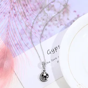 Silver alloy moon star pendant necklace close-up, rhinestone crystal detail accessory showcase.