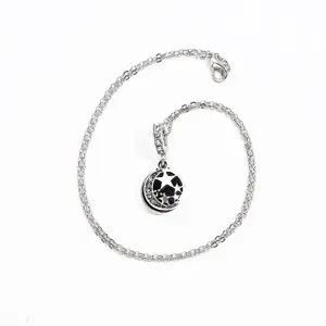 Silver star and moon charm necklace with sparkling crystals and black enamel design details.