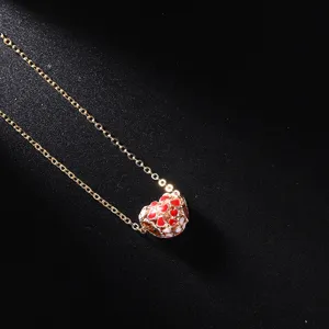 Exquisite gold-tone chain necklace featuring a charming red and white heart pendant design.