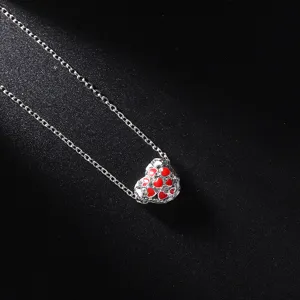 Silver-tone clavicle necklace featuring a heart pendant with red and white enamel details.