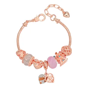 Detailed view of a rose gold charm bracelet with pink beads, heart and ferris wheel.