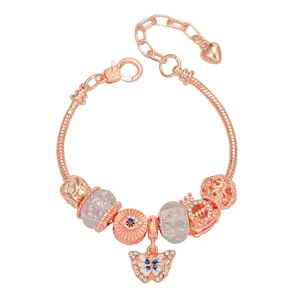 Exquisite details of the rose gold charm bracelet featuring a sparkling butterfly pendant.