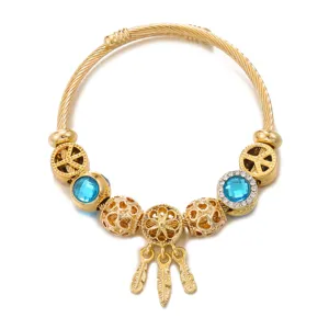 Gold stainless steel cable wire charm bracelet with blue crystal beads and dreamcatcher.