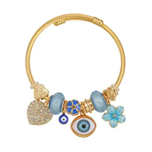 Bracciale rigido aperto con ciondoli malocchio dorato strass cristallo fiore blu gioiello