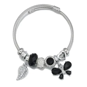 Silver stainless steel charm bangle bracelet featuring black crystal beads and butterfly leaf pendants.