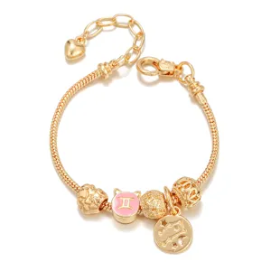 Gold-colored Gemini zodiac charm snake chain bracelet with custom beads and constellation pendant.