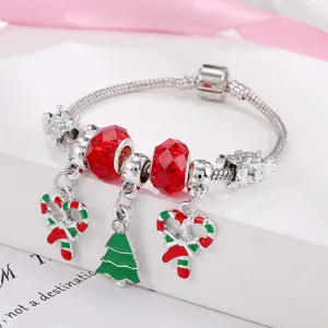 Christmas charm bracelet with red crystal beads, candy cane and tree pendants for holiday gifts.