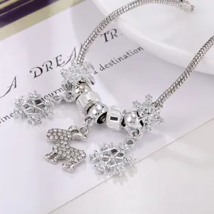 Silver Christmas charm bracelet detail with sparkling snowflake and reindeer pendants.