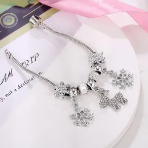 Detailed shot of Christmas silver charm bracelet with sparkling snowflake and reindeer pendants.