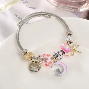 Nahaufnahme des rosafarbenen Kristall-Charm-Armbands mit süßem Mond-Katze und Libellen-Anhänger.