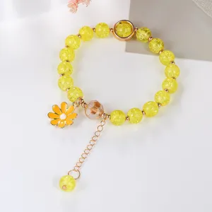 Yellow crackle crystal bracelet with cute daisy pendant detailed view close up style
