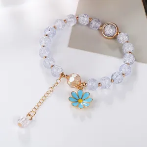Detailed view of cracked crystal bead bracelet featuring a cute blue daisy pendant and extension chain.