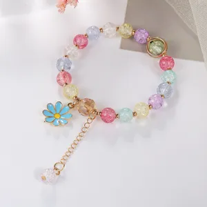 Detailed view of the colorful crackle crystal bracelet featuring a cute blue daisy pendant.