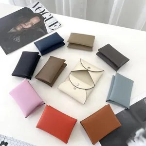 Leather card holder detail view, elegant envelope design, multiple vibrant colors available.