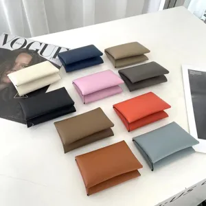 Detailed view of colorful leather card holders featuring palm grain texture and folding design.