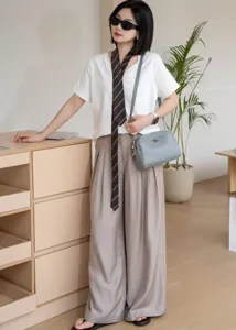 Grey genuine leather shoulder bag for women, elegant turn-lock crossbody bag with minimalist style.