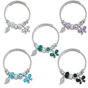 Stainless steel cable wire bracelet set featuring crystal butterfly and leaf charms for women.