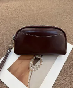 Women genuine leather minimalist clutch bag, elegant dark brown wristlet purse for daily use.
