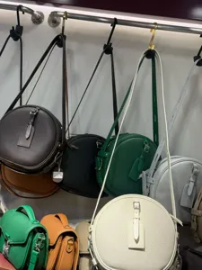 Vintage genuine cowhide round crossbody bag detail showcasing multiple fashion colors and hardware.