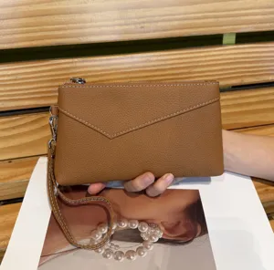 Brown leather clutch bag for women, large capacity wristlet wallet with zipper and envelope flap.