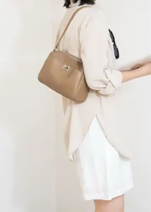 Genuine leather shoulder bag detail, stylish turn-lock design, perfect everyday accessory.