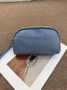 Genuine leather women's minimalist clutch bag, stylish blue wristlet purse for daily use.