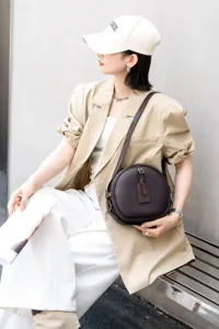 Detailed view of the retro cowhide round crossbody bag showcasing its soft texture and hardware.