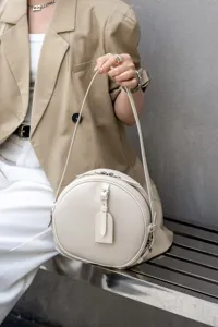 Elegant white genuine leather round shoulder bag with minimalist design, versatile crossbody.