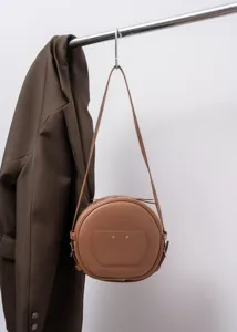 Retro genuine leather round crossbody bag, stylish brown cowhide shoulder bag for women.