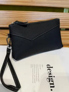 Black genuine leather clutch bag for women, stylish envelope purse with wrist strap and zipper.