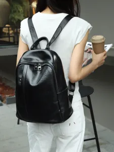 Detail view of black genuine leather women backpack showing soft texture and spacious capacity.