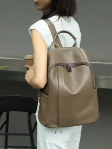 Detailed view of soft leather backpack in taupe color worn by model, casual style for daily use.