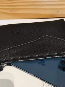 Black genuine leather clutch bag for women, large capacity zipper purse wallet with white stitching.