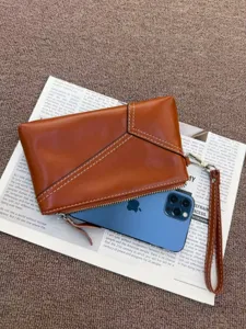 Vintage leather wristlet clutch bag for women, genuine cowhide phone purse detail view.