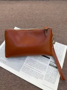Detailed view of retro genuine leather women clutch, brown soft cowhide wallet for phone.