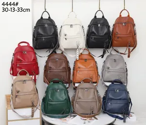 Detailed view of multi-color genuine leather backpacks showing fine texture and craftsmanship.