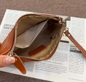 Interior detail view of the retro genuine leather brown pouch showing spacious capacity.