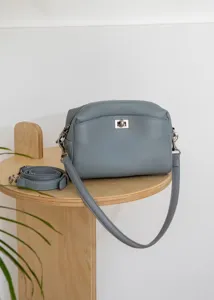 Blue grey genuine leather shoulder bag detail showing silver turn lock and detachable strap.