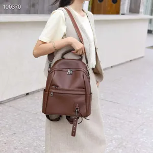 Detail view of the brown genuine leather backpack showcasing fine texture and daily practicality.