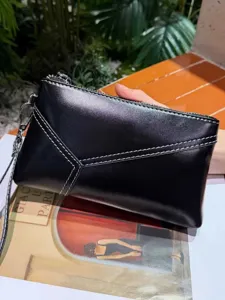 Black leather clutch bag with geometric stitching design, elegant daily wristlet purse.