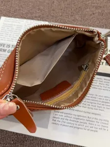 Vintage genuine cowhide leather clutch bag for women, zipper closure with large capacity.